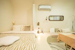 a room with a bed and a mirror on the wall at Shanghai Hills & Well-time Homestay in Shanghai