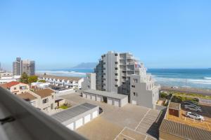 a view of the ocean from the balcony of a building at Ocean View 503 in Bloubergstrand