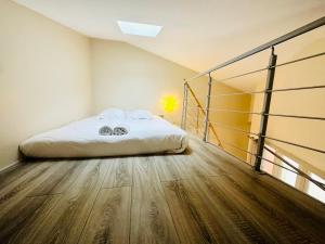 a bedroom with a bed and a wooden floor at Maison Stylée 98m2 centre bordeaux in Bordeaux