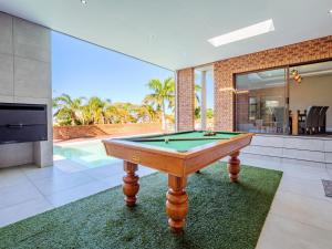 a pool table in the middle of a living room at One on Chelsea in Durban
