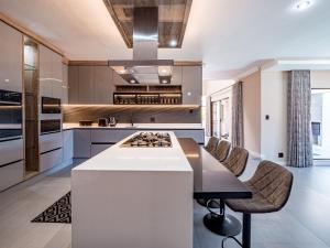 a kitchen with a white island with a counter top at One on Chelsea in Durban