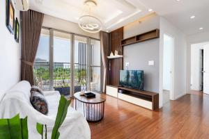 a living room with a couch and a tv at Lee's apartment at Scenicvalley in Ho Chi Minh City