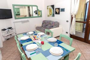 uma sala de jantar com uma mesa azul e cadeiras em La casa di Gabry in residence con piscina comune em Tavernola Bergamasca