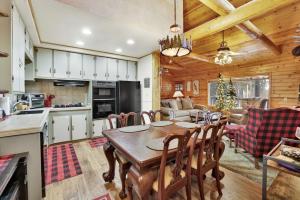 a kitchen and living room with a table and chairs at 2417-Timber Pines Chalet cabin in Big Bear Lake