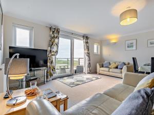 a living room with a couch and a tv at 3 Bed in Newquay SPINS in Newquay