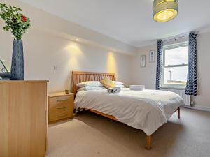 a bedroom with a bed and a vase of flowers at 3 Bed in Newquay SPINS in Newquay