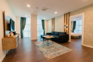 a living room with a couch and a table at Sabırlar City Suites Hotel in Trabzon