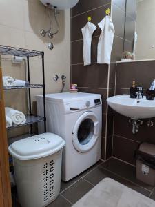 a bathroom with a washing machine and a sink at Apartman Cherine in Mostar