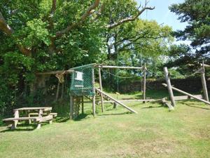 a batting cage and a bench in a park at 3 Bed in Bude NPOAK in Poundstock