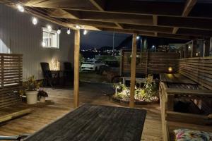 an outdoor deck with a table and a grill at The Fjord House in Snofugl +15 photos