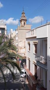 a building with a clock tower in a city at Carbo Home moderno, Algemesi Home in Algemesí