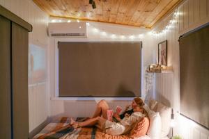 two people laying on a bed in front of a screen at Wildflower On The Rocks in Rock Valley