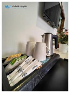 a kitchen counter with a coffee pot and utensils at Weibdeh Heights Apartments in Amman