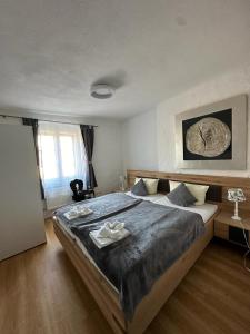 a bedroom with a large bed with a wooden frame at Hotel Zum Goldenen Anker in Bamberg