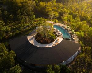 an overhead view of a swimming pool in a forest at Grün Resort Uluwatu in Uluwatu