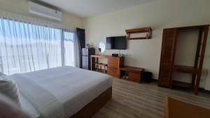 a hotel room with a bed and a television at 22 Twenty Two Chiang Mai in Chiang Mai