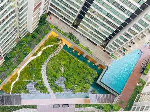 an overhead view of a pool in a city with tall buildings at Empire Hostel Regalia in Kuala Lumpur