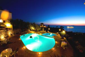 a view of two swimming pools at night at Hotel Villa Lubrense Sorrento in Massa Lubrense