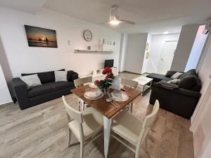 salon ze stołem oraz salon z kanapą w obiekcie Apartamento Empul La Barrosa w mieście Chiclana de la Frontera
