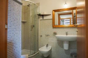 a bathroom with a sink and a toilet and a shower at Casale Del Borgo in San Severino +36 photos