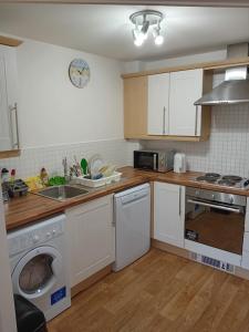 cocina con lavadora y lavadora en Apartment closer to the city centre en Mánchester