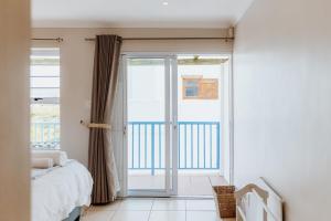 a bedroom with a bed and a sliding glass door at Sterretjie in Paternoster +52 photos