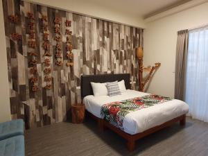 A bed or beds in a room at Inn巷文創旅店 Inn siang B&B-墾丁夢幻島