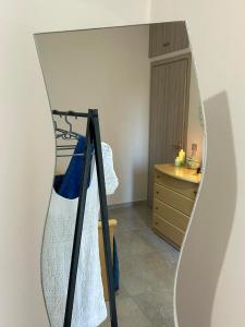 a mirror on a wall next to a dresser at Emyria-Ground Floor Apartment in Zakynthos Town +16 photos
