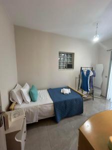 a bedroom with a bed with a blue blanket at Emyria-Ground Floor Apartment in Zakynthos Town