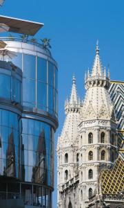 a tall white building with two towers next to at DO&CO Hotel Vienna in Vienna