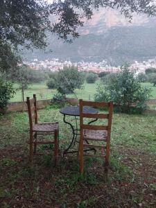 a table and two chairs sitting next to a table at Simbas House in Leonidio