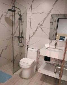 a bathroom with a shower and a toilet and a sink at Venice Star Grand Hotel in Manila