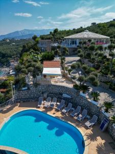 a view of a pool and chairs and a resort at Hotel Villa Lubrense Sorrento in Massa Lubrense