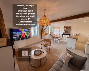 a living room with a couch and a table at Le Loft de Babolène in Villefranche-de-Rouergue