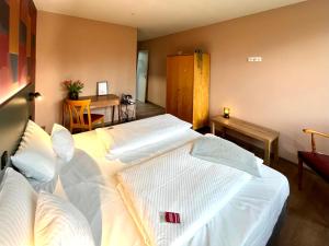 a hotel room with two beds and a desk at Kloster-Quartier in Münster