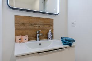 a bathroom with a sink and a mirror at LA MAISON DES VIGNES SAINT EMILION in Saint-Émilion +50 photos