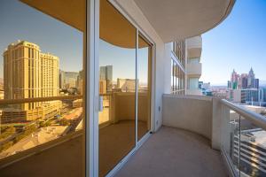 an apartment balcony with a view of the city at No Resort Fee Strip View Balcony+ Valet Parking in Las Vegas