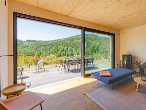 a living room with a large sliding glass door at Sauerland Lodge - Haus Luise in Winterberg
