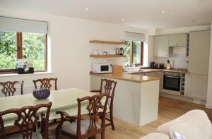 a kitchen and dining room with a table and chairs at Middledown in Alton