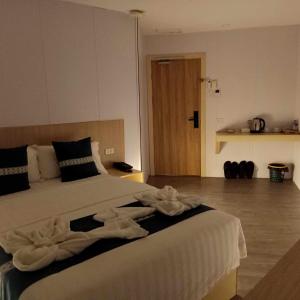 a bedroom with a bed with towels on it at Venice Star Grand Hotel in Manila