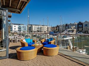 a group of chairs and tables on a dock with a marina at 2 Bed in Brightlingsea HARSI in Saint Osyth