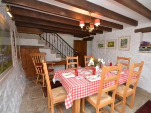 a dining room with a table and wooden chairs at 3 Bed in Widecombe-in-the-Moor 36683 in Widecombe in the Moor