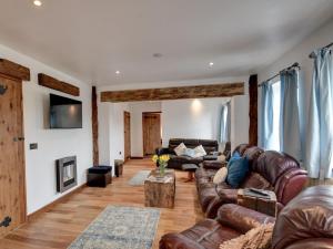 a living room with leather couches and a table at 3 Bed in York 37254 in Fangfoss