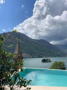 a view of a lake with a boat in the water at Monte Bay Retreat Villa in Perast