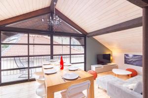 a living room with a table and a large window at La Polaire - 3 chambres télécabine à 200m in Ax-les-Thermes
