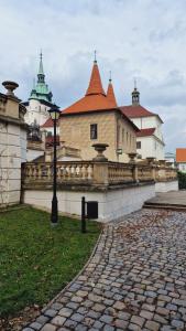 a building with a street light next to a brick sidewalk at TEPLA II in Teplice