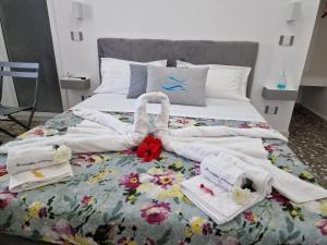a bed with towels and towels on top of it at Meraviglia d'Otranto in Otranto