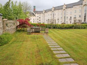 a park bench in front of a large building at 3 Bed in City Centre E1986 in Edinburgh