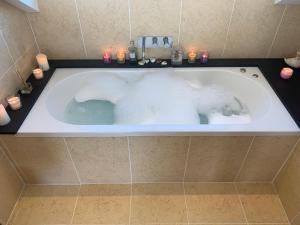 a bath tub with a polar bear in it at The Penthouse Bowness Tranquil Loft Jacuzzi Bath & Complimentary Cascades Spa Membership in Bowness-on-Windermere
