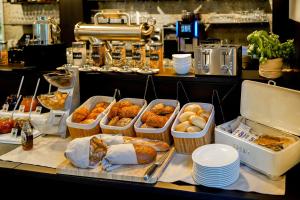 a buffet with several trays of different types of food at Gandersheimer Boardinghouse in Bad Gandersheim
